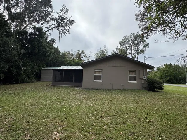 a backyard of a house with yard and trampoline