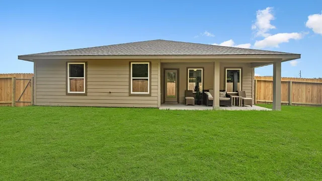 a view of a house with a backyard