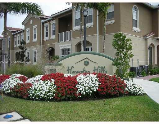 5930 Abbey Road Tamarac, FL 33321 - Photo 21 of 26 a front view of a house with a garden