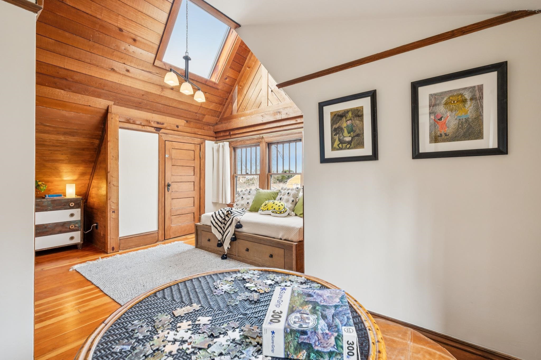 2012 Rose Street Berkeley, CA 94709 - Photo 32 of 57 Bedroom with a skylight, lofted ceiling, hardwood / wood-style flooring, and wood walls