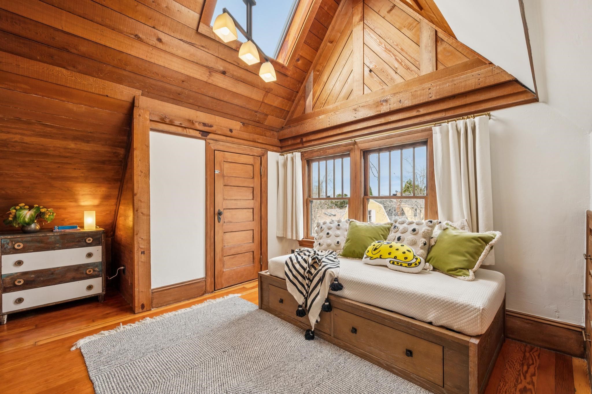 2012 Rose Street Berkeley, CA 94709 - Photo 33 of 57 Bedroom featuring a skylight, hardwood / wood-style floors, a vaulted wood ceiling, and wooden walls