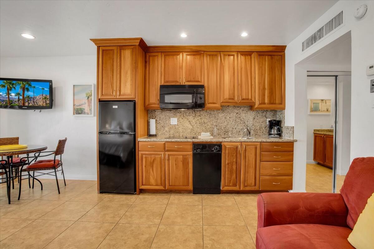 73850 Fairway Drive, Unit 18 Palm Desert, CA 92260 - Photo 11 of 42 a kitchen with stainless steel appliances granite countertop a granite counter tops and a refrigerator