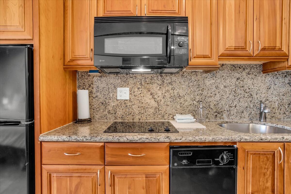 73850 Fairway Drive, Unit 18 Palm Desert, CA 92260 - Photo 13 of 42 a kitchen with granite countertop a sink and a stove