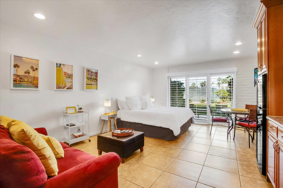 73850 Fairway Drive, Unit 18 Palm Desert, CA 92260 - Photo 2 of 42 a living room with furniture and a floor to ceiling window