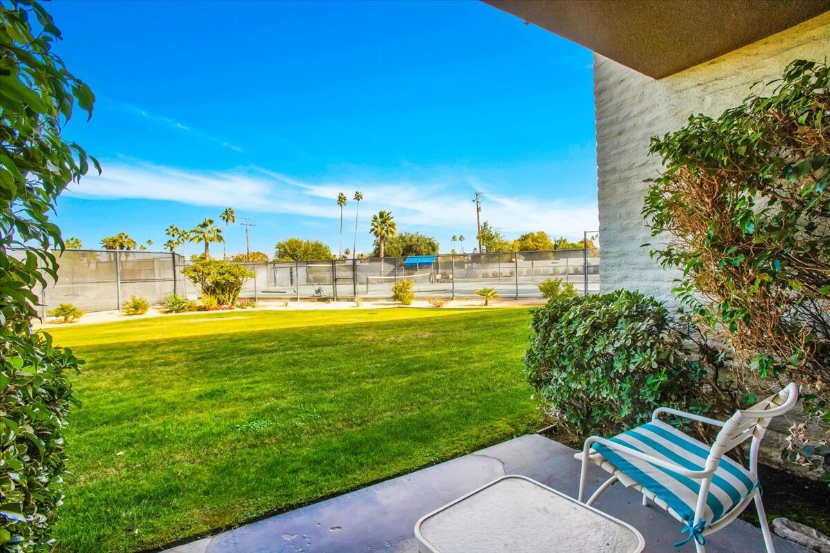 73850 Fairway Drive, Unit 18 Palm Desert, CA 92260 - Photo 23 of 42 a view of a swimming pool with lawn chairs and a big yard
