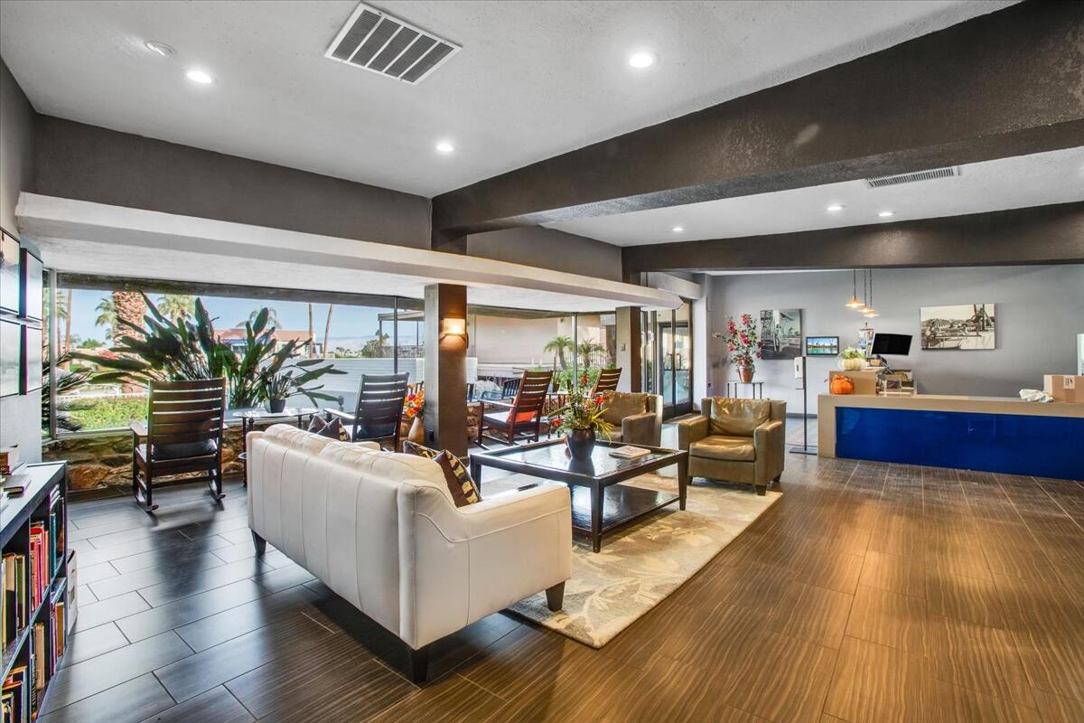 73850 Fairway Drive, Unit 18 Palm Desert, CA 92260 - Photo 27 of 42 a living room with furniture and a large window