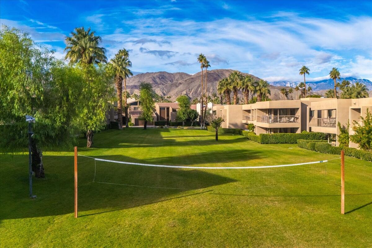 73850 Fairway Drive, Unit 18 Palm Desert, CA 92260 - Photo 32 of 42 a view of a tennis ground with large trees