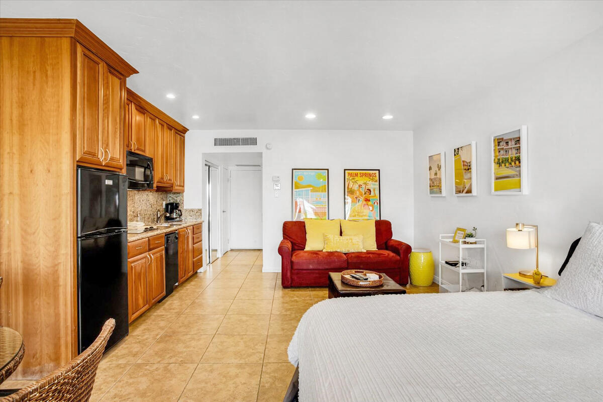 73850 Fairway Drive, Unit 18 Palm Desert, CA 92260 - Photo 5 of 42 a spacious bedroom with a bed a couch and dresser