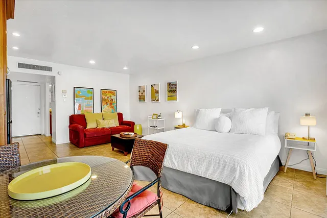 a bedroom with bed and a couch