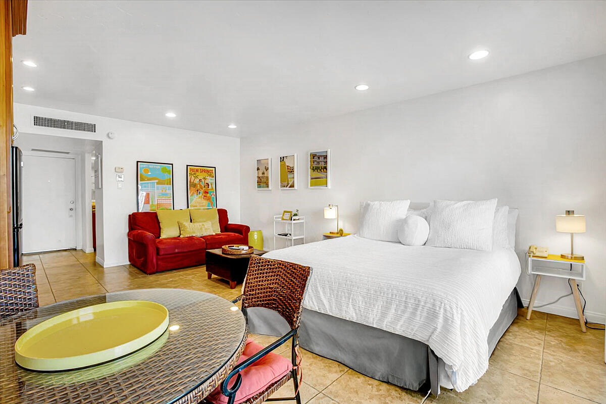 73850 Fairway Drive, Unit 18 Palm Desert, CA 92260 - Photo 6 of 42 a bedroom with bed and a couch