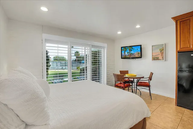 a bed room with a bed and a chair