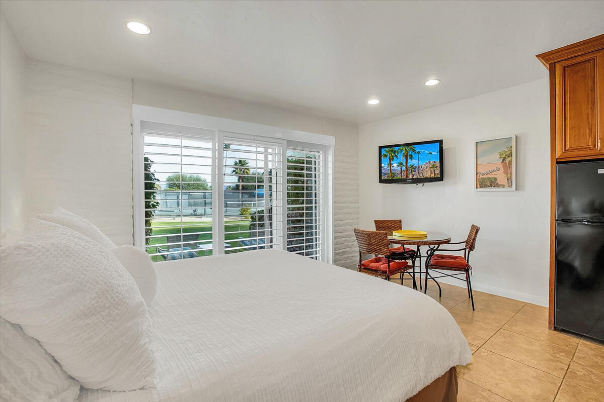 73850 Fairway Drive, Unit 18 Palm Desert, CA 92260 - Photo 9 of 42 a bed room with a bed and a chair