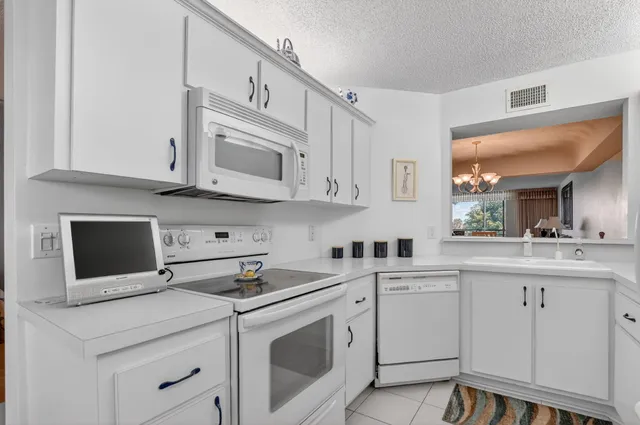 a kitchen with stainless steel appliances granite countertop a sink a stove and cabinets