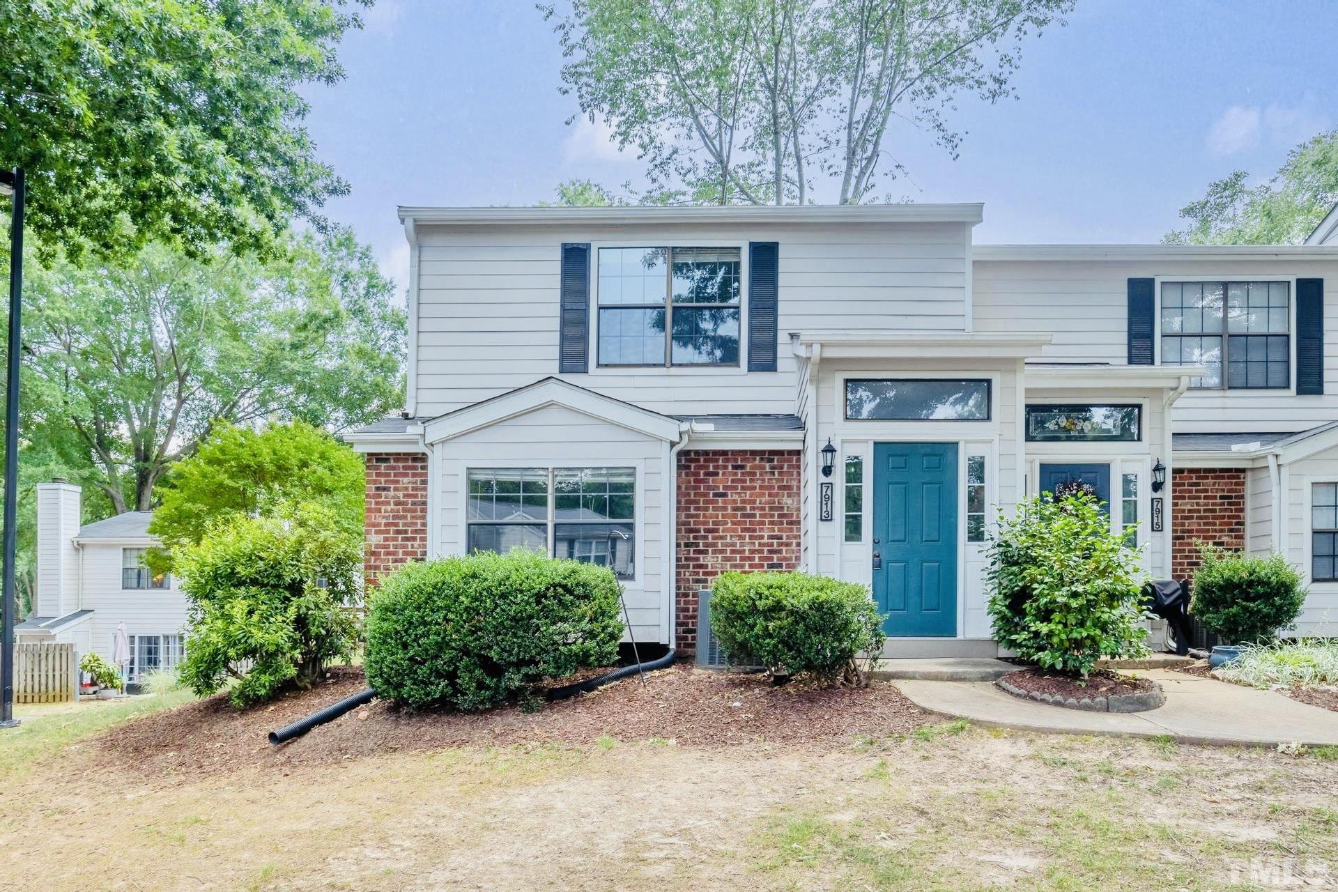 7913 Falcon Rest Circle Raleigh, NC 27615 - Photo 1 of 22 front view of a house with a garden