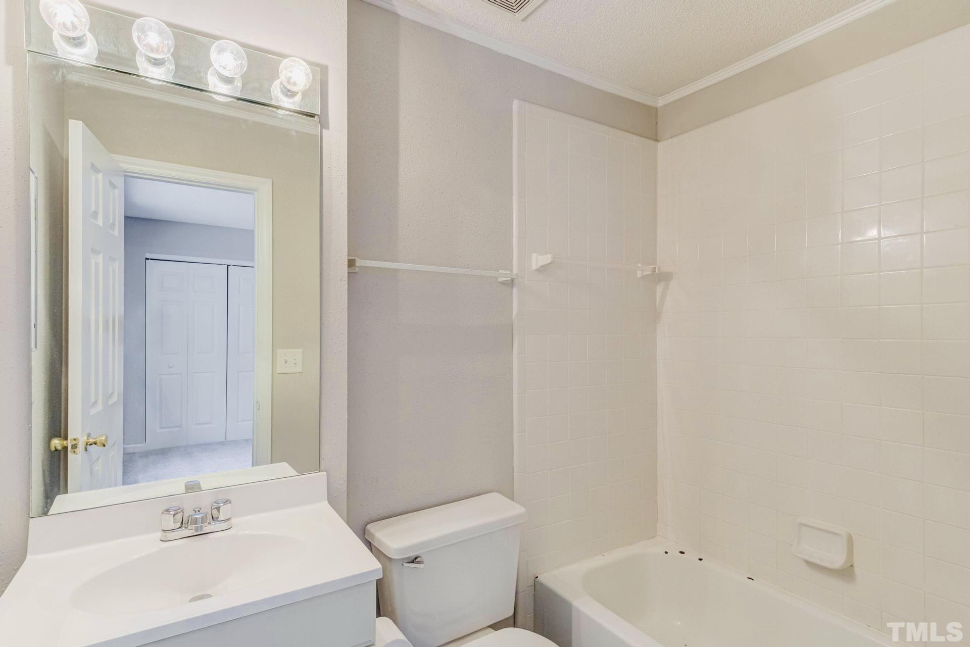 7913 Falcon Rest Circle Raleigh, NC 27615 - Photo 14 of 22 a bathroom with a sink a toilet and shower