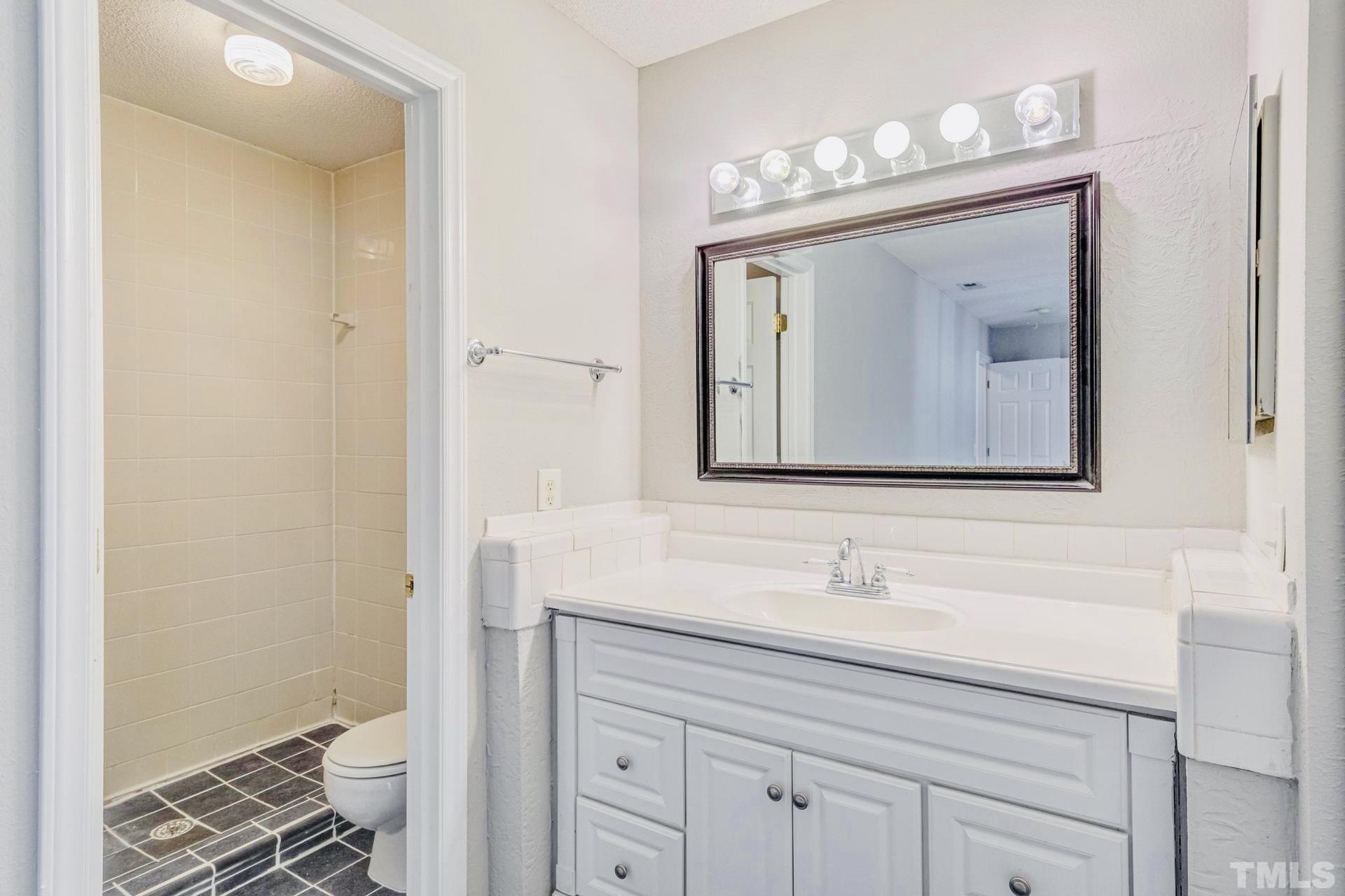 7913 Falcon Rest Circle Raleigh, NC 27615 - Photo 18 of 22 a bathroom with a sink vanity and a mirror