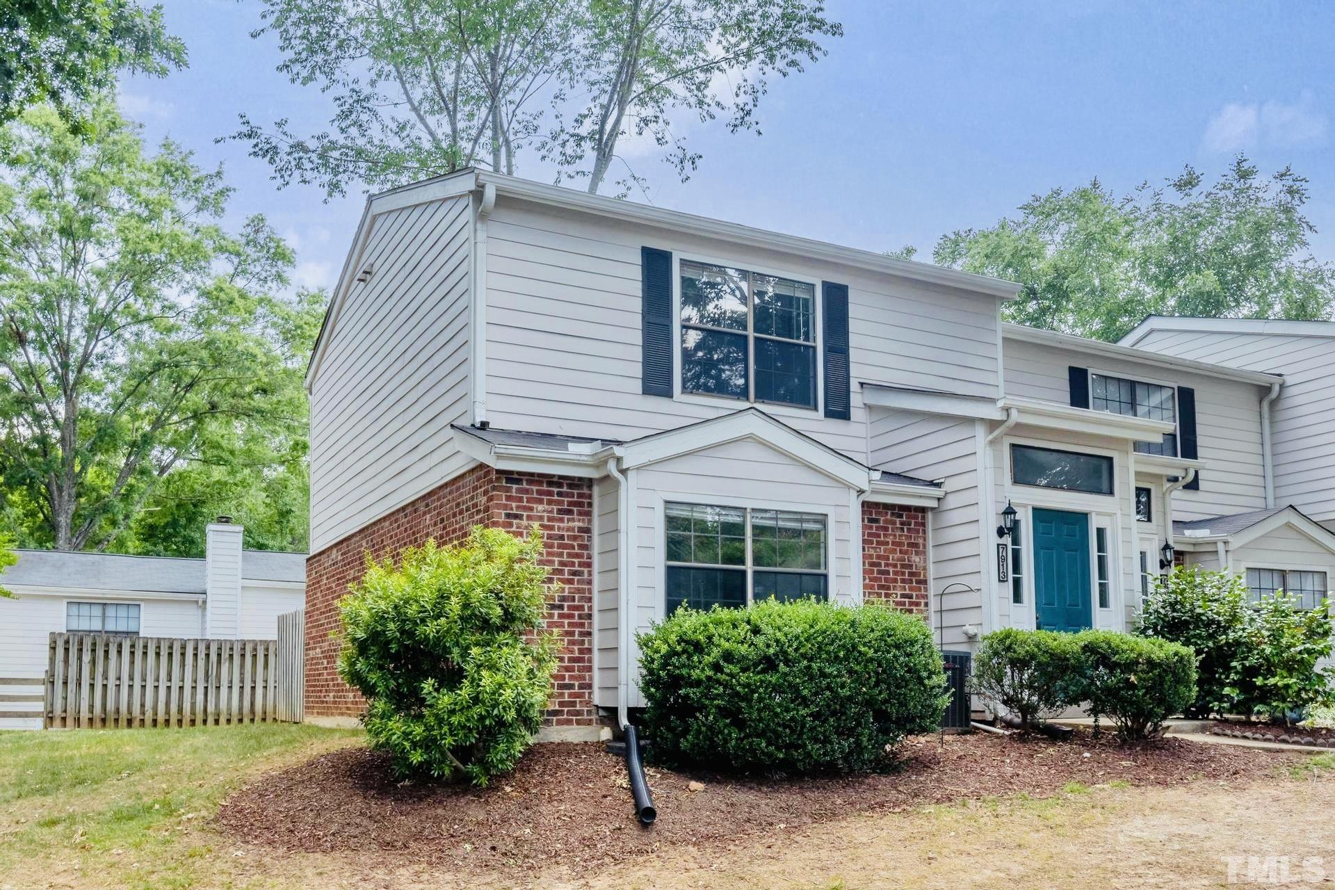 7913 Falcon Rest Circle Raleigh, NC 27615 - Photo 2 of 22 a front view of a house with a garden