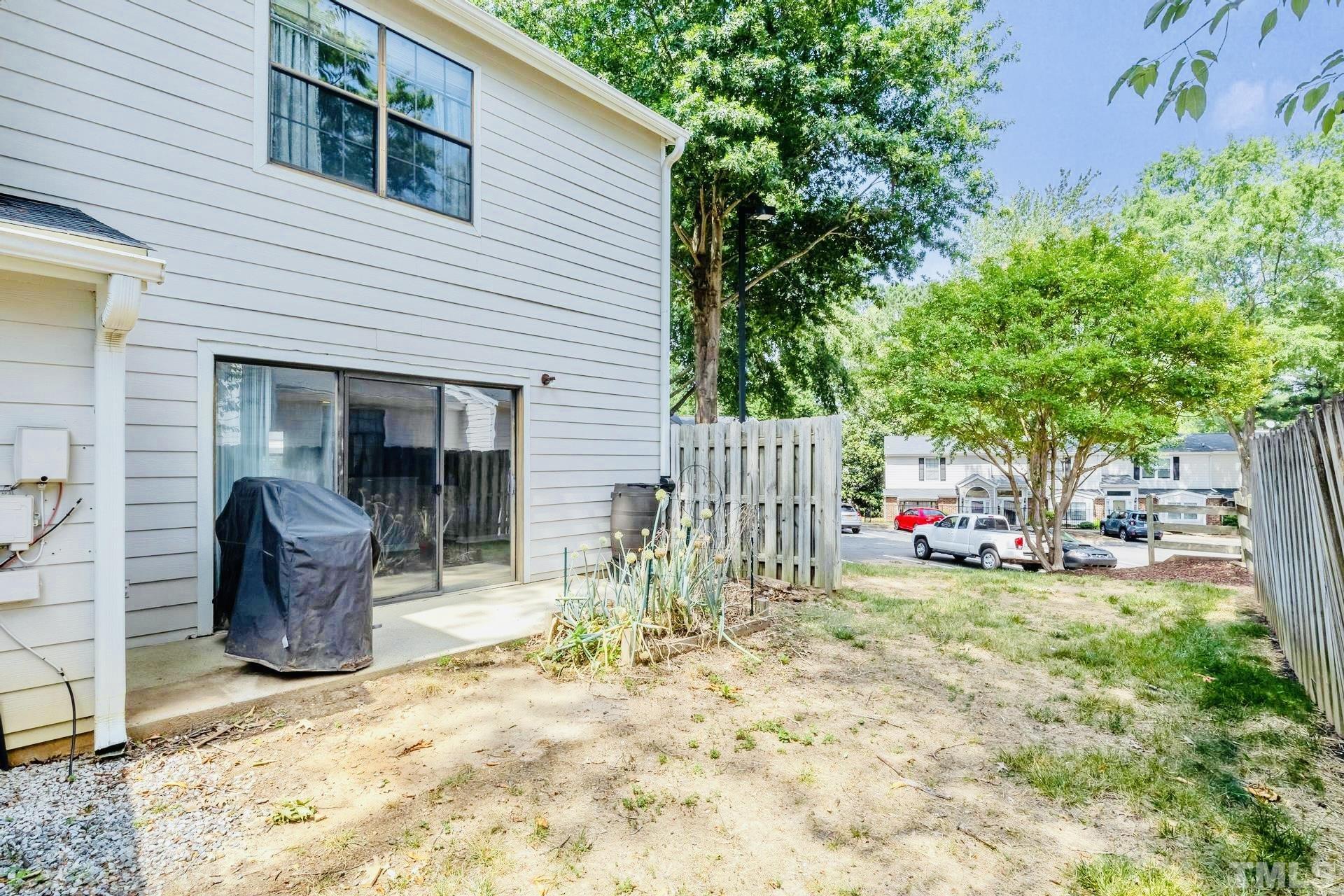 7913 Falcon Rest Circle Raleigh, NC 27615 - Photo 21 of 22 a view of a patio with table and chairs and potted plants