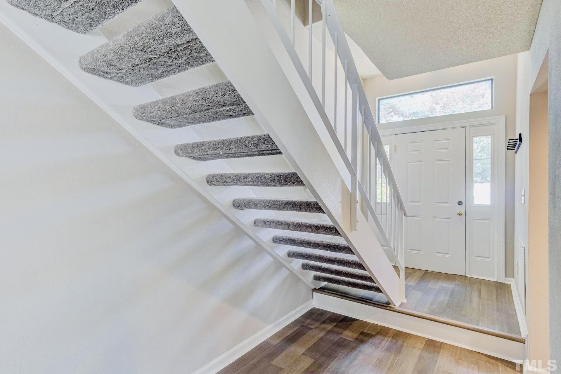 7913 Falcon Rest Circle Raleigh, NC 27615 - Photo 3 of 22 a view of entryway and hall with wooden floor