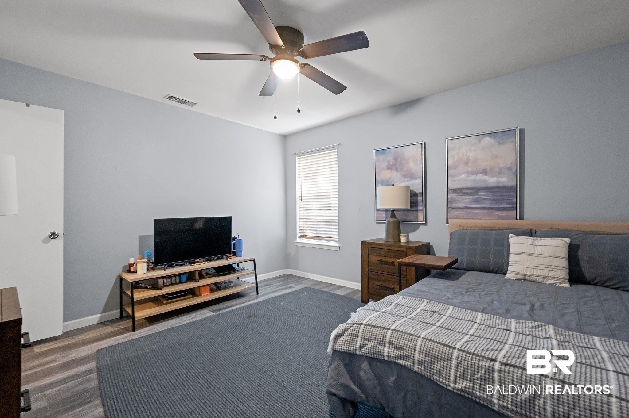 4724 Wicker Way Mobile, AL 36609 - Photo 28 of 36 Interior room featuring wood-finish flooring, a ceiling fan with integrated lighting, and a window with blinds