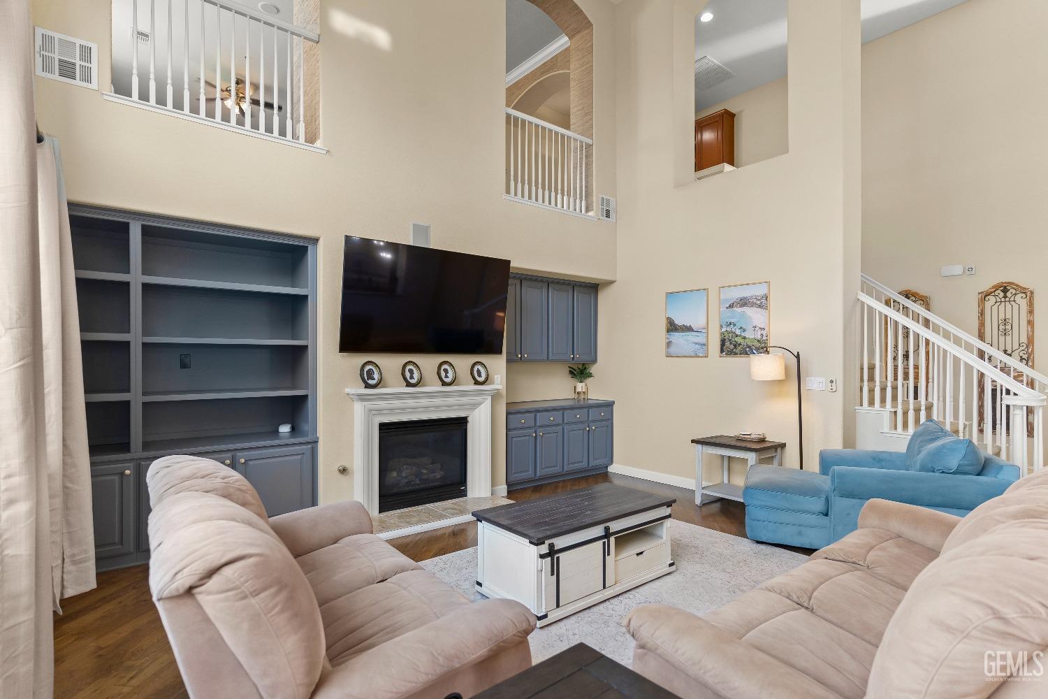 Undisclosed Address Bakersfield, CA 93314 - Photo 12 of 46 a living room with furniture a fireplace and a flat screen tv