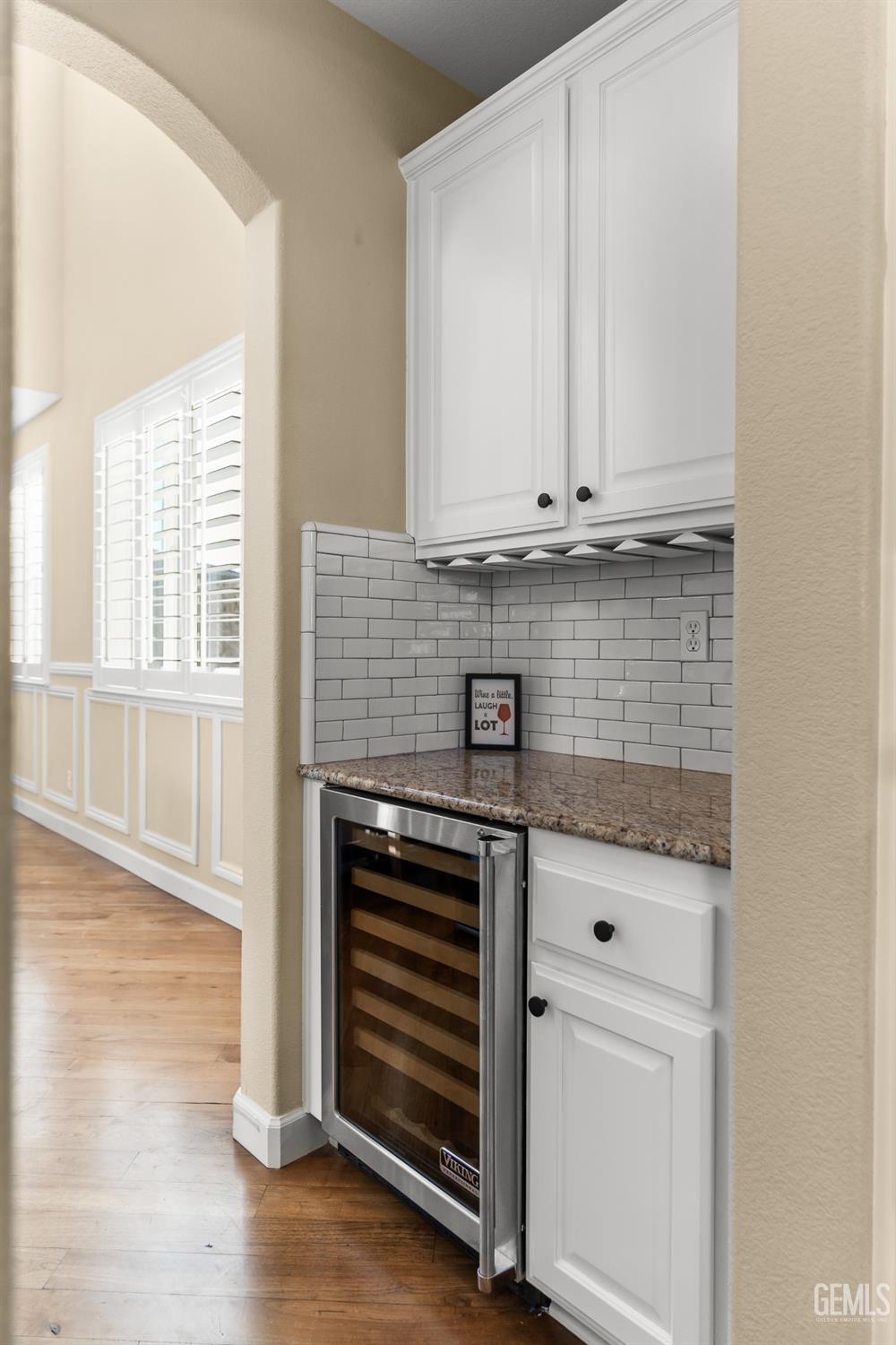 Undisclosed Address Bakersfield, CA 93314 - Photo 14 of 46 a kitchen with granite countertop white cabinets and stainless steel appliances