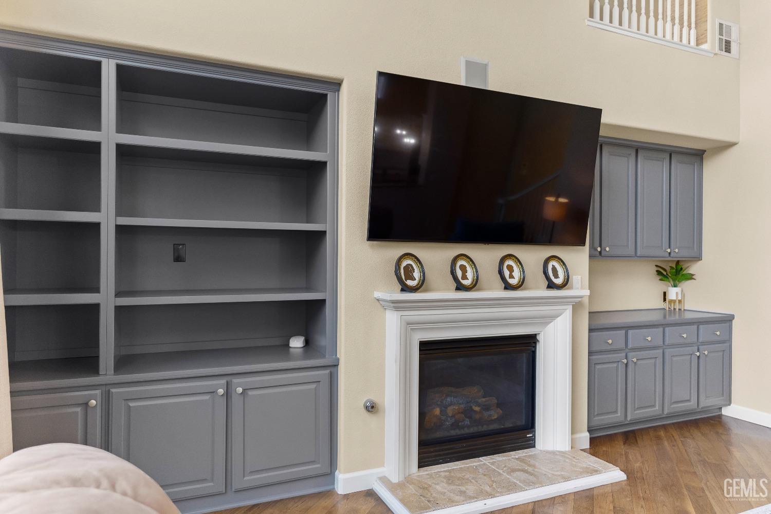 Undisclosed Address Bakersfield, CA 93314 - Photo 19 of 46 a living room with a fireplace and a flat screen tv