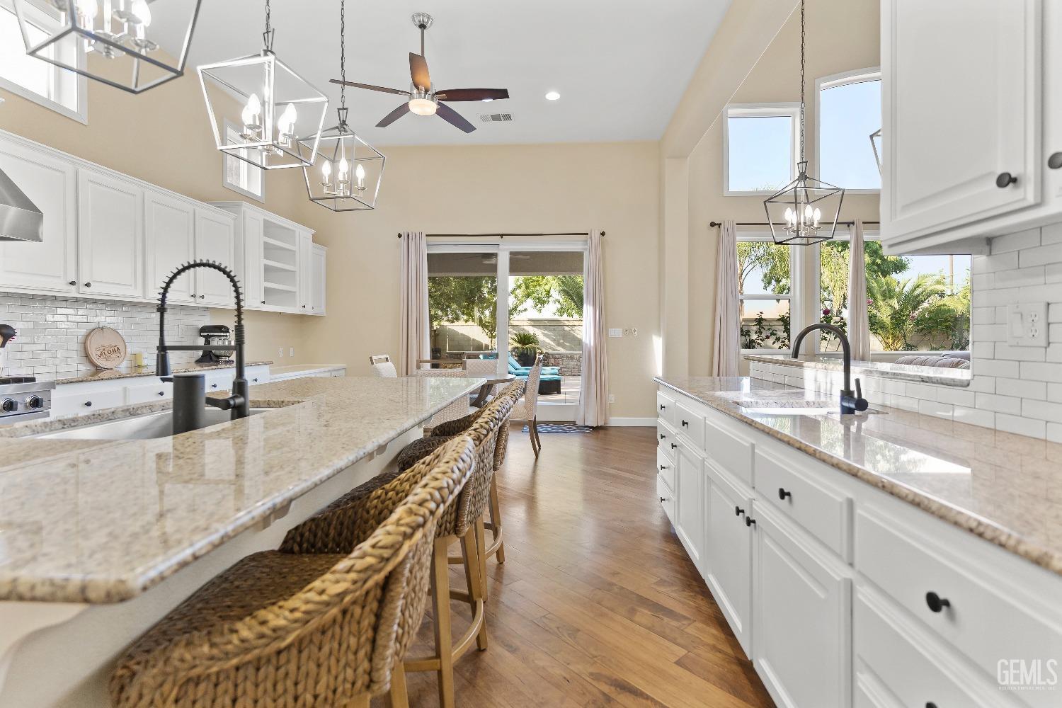 Undisclosed Address Bakersfield, CA 93314 - Photo 26 of 46 a large kitchen with kitchen island lots of counter space a sink appliances and a large window
