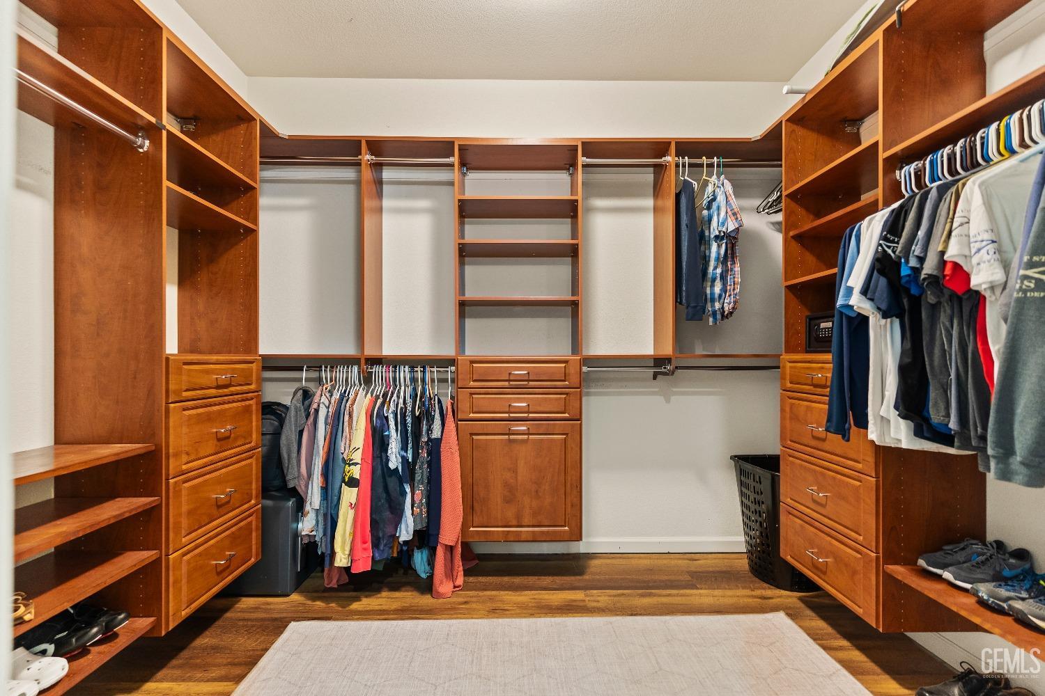 Undisclosed Address Bakersfield, CA 93314 - Photo 35 of 46 a view of walk in closet with clothes and shoes