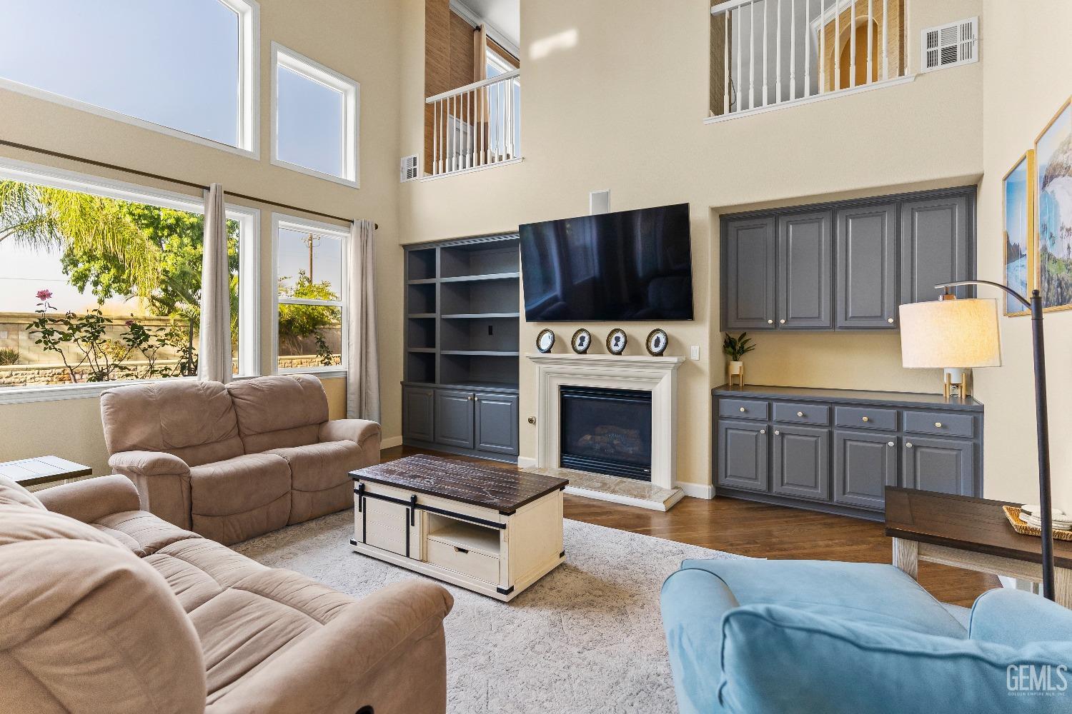 Undisclosed Address Bakersfield, CA 93314 - Photo 38 of 46 a living room with furniture a fireplace and a large window