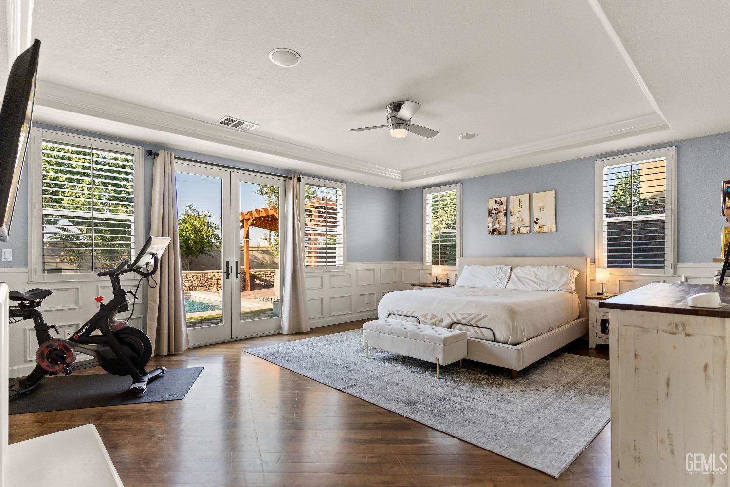 Undisclosed Address Bakersfield, CA 93314 - Photo 45 of 46 a spacious bedroom with a large bed and a chandelier