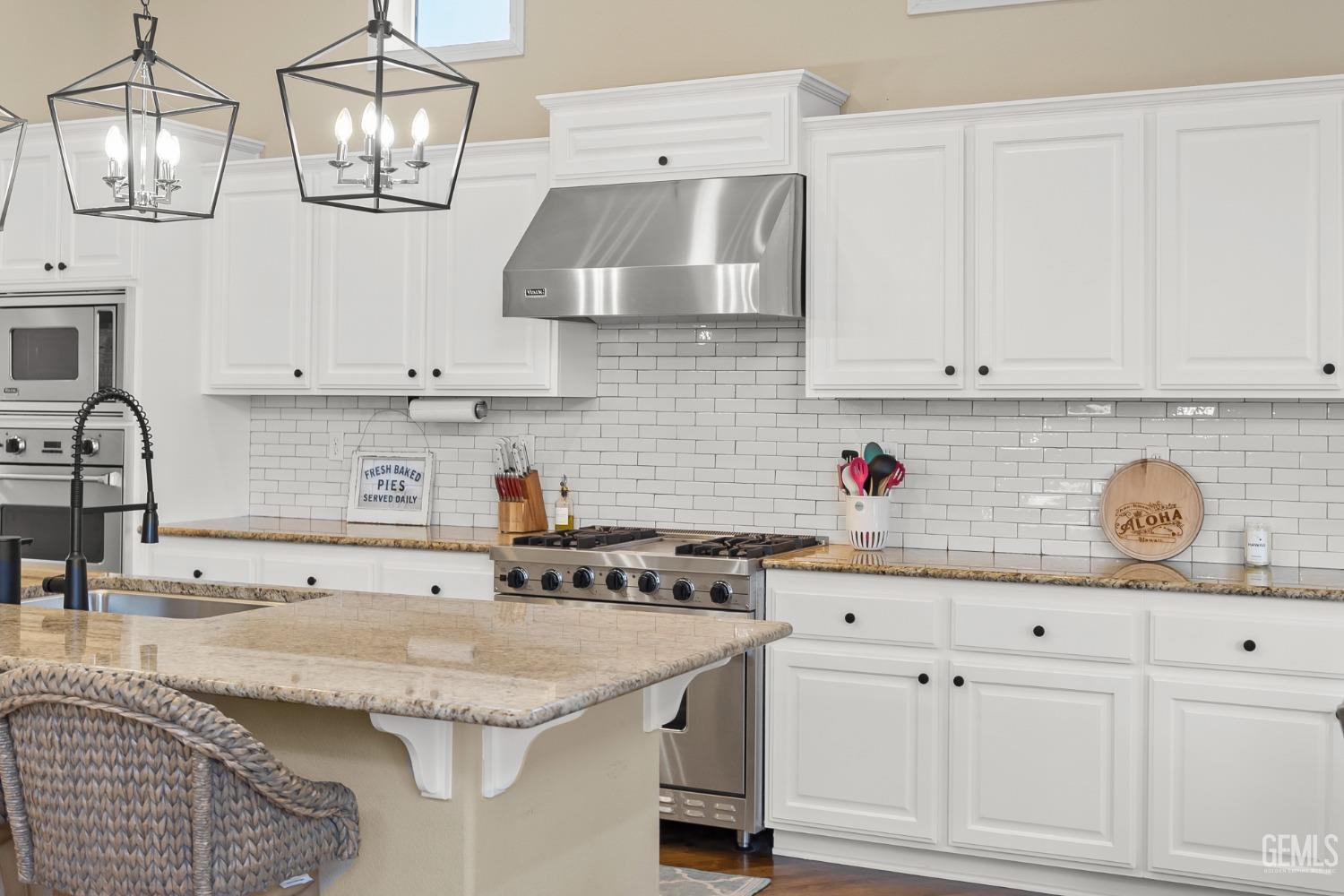 Undisclosed Address Bakersfield, CA 93314 - Photo 6 of 46 a kitchen with granite countertop a sink stainless steel appliances and cabinets