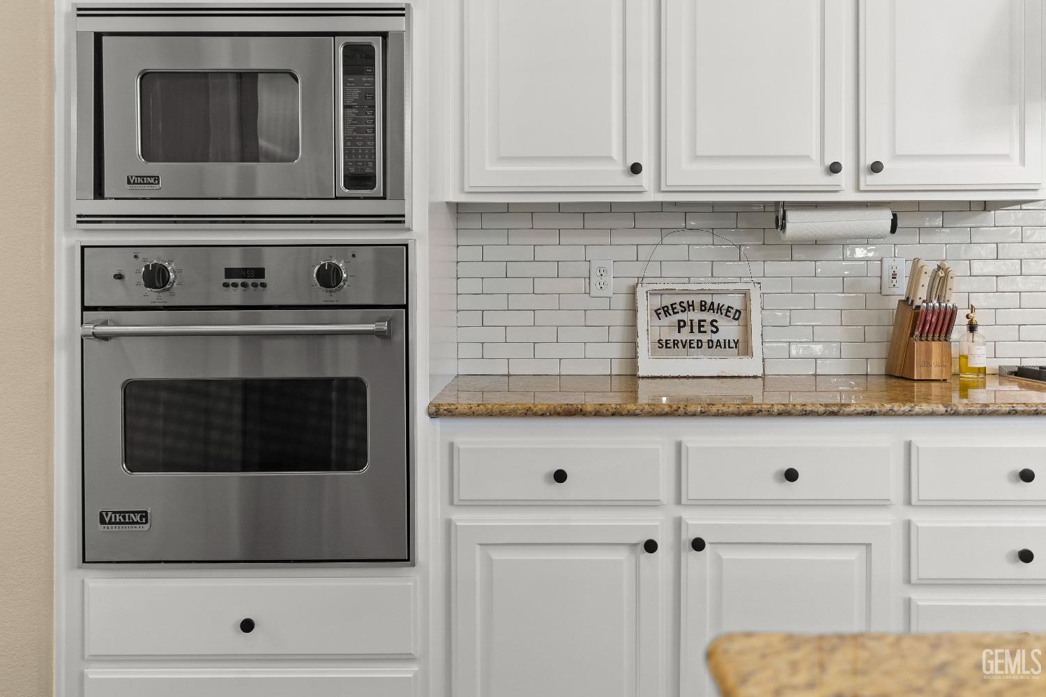 Undisclosed Address Bakersfield, CA 93314 - Photo 7 of 46 a kitchen with white cabinets and oven