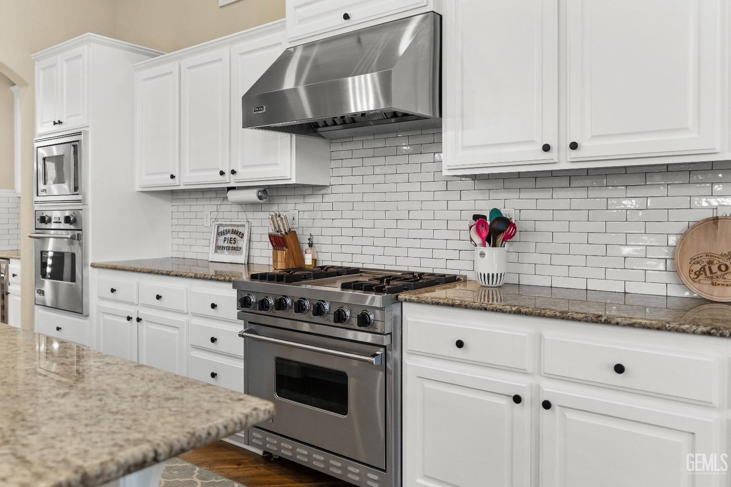 Undisclosed Address Bakersfield, CA 93314 - Photo 9 of 46 a kitchen with stainless steel appliances granite countertop white cabinets and a stove