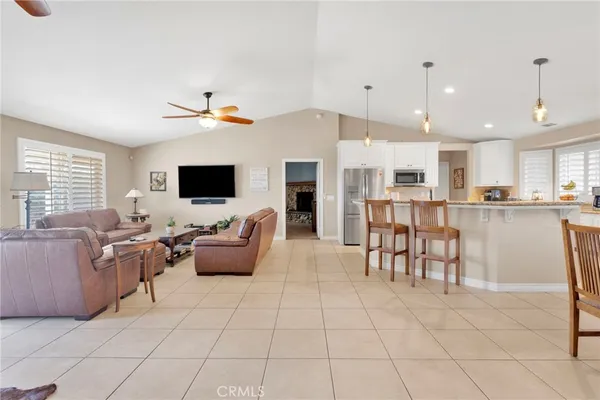 a living room with furniture and kitchen view