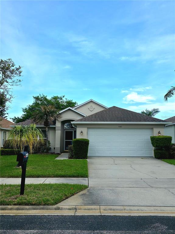 a front view of house with yard and green space