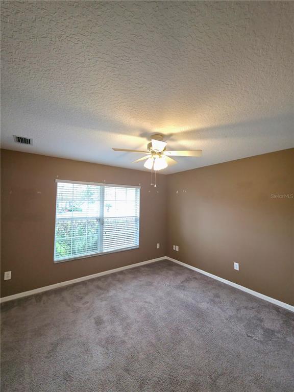 5465 High Pasture Way Melbourne, FL 32940 - Photo 20 of 39 an empty room with a empty space and windows