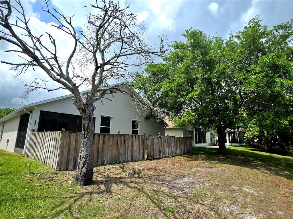 5465 High Pasture Way Melbourne, FL 32940 - Photo 29 of 39 a front view of a house with a yard and tree s