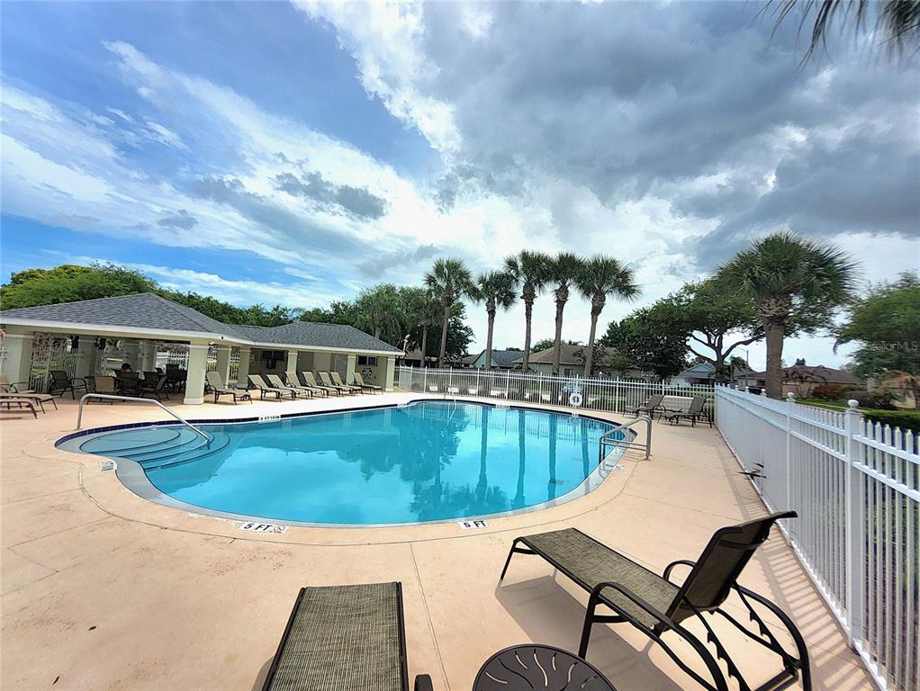 5465 High Pasture Way Melbourne, FL 32940 - Photo 35 of 39 a view of a swimming pool with lounge chairs in patio