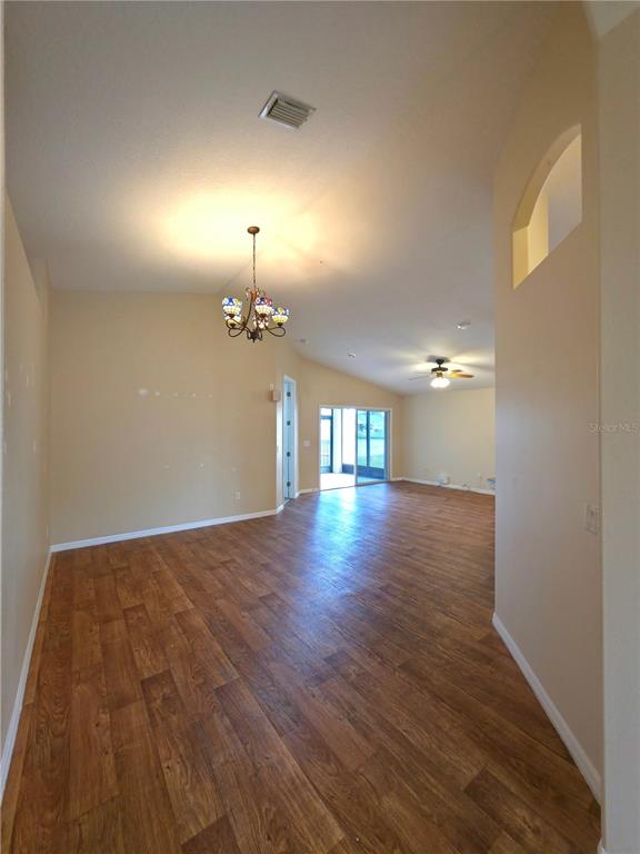 5465 High Pasture Way Melbourne, FL 32940 - Photo 7 of 39 wooden floor in an empty room with a window