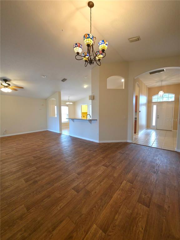 5465 High Pasture Way Melbourne, FL 32940 - Photo 8 of 39 a view of a room with chandelier fan and wooden floor