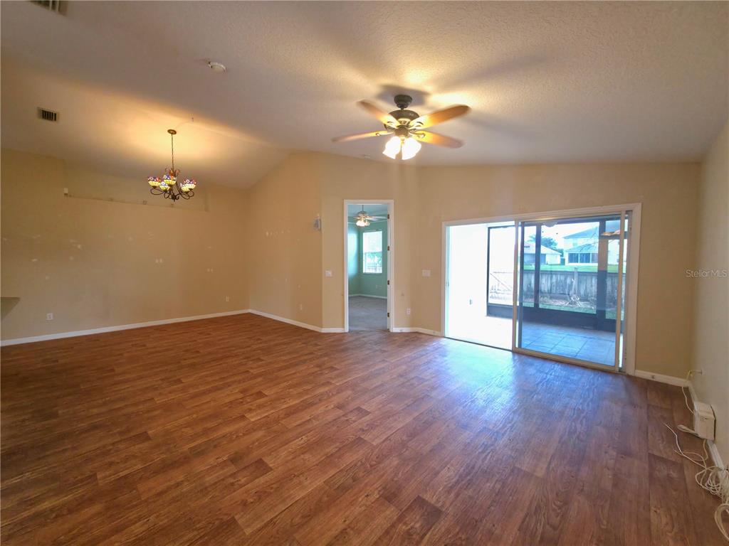 5465 High Pasture Way Melbourne, FL 32940 - Photo 9 of 39 a view of an empty room with a window and wooden floor