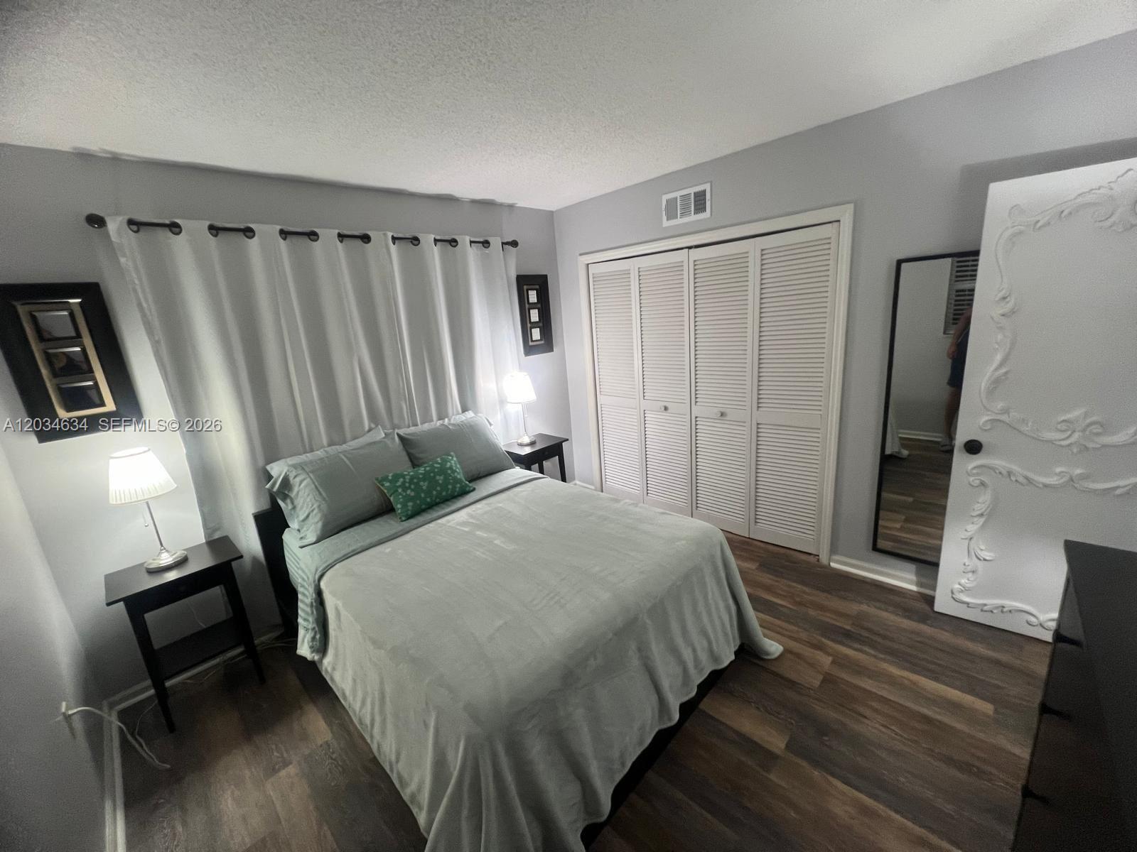 9880 Marina Boulevard, Unit 1516 Boca Raton, FL 33428 - Photo 17 of 32 a bed room with a bed and a mirror