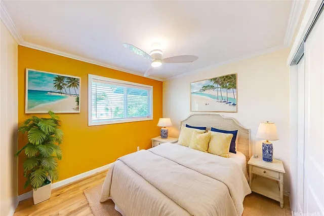 a bedroom with a bed and painting on the wall