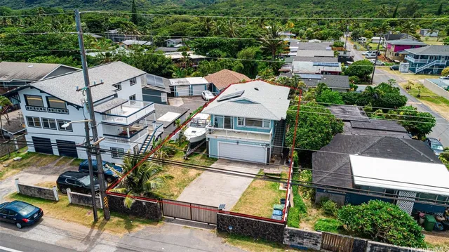 an aerial view of a house with garden space and street view