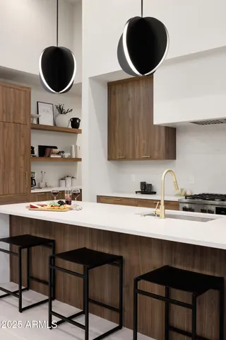 a kitchen with a refrigerator a stove and cabinets