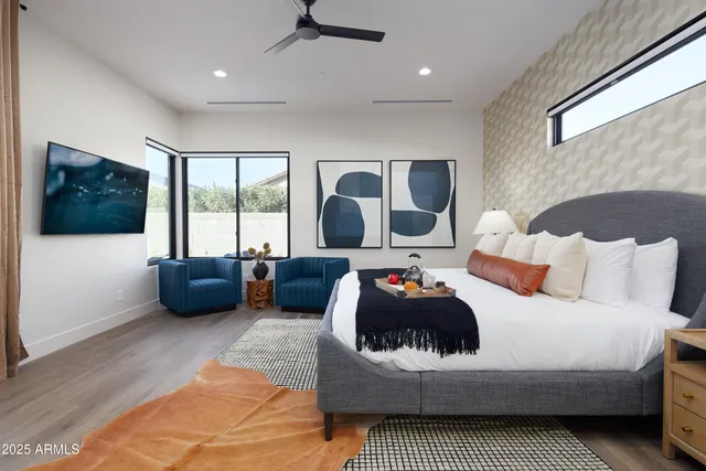 a bedroom with a large bed and a large window