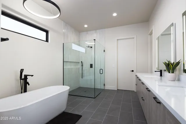 a bathroom with a double vanity sink and mirror