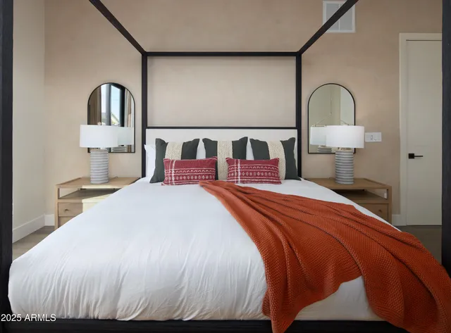 a bedroom with two beds and wooden floor