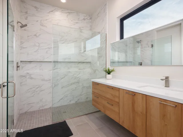 a bedroom with two beds and painting on the wall